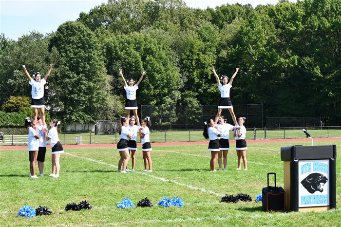 Rye Neck cheerleaders mid-routine on the field