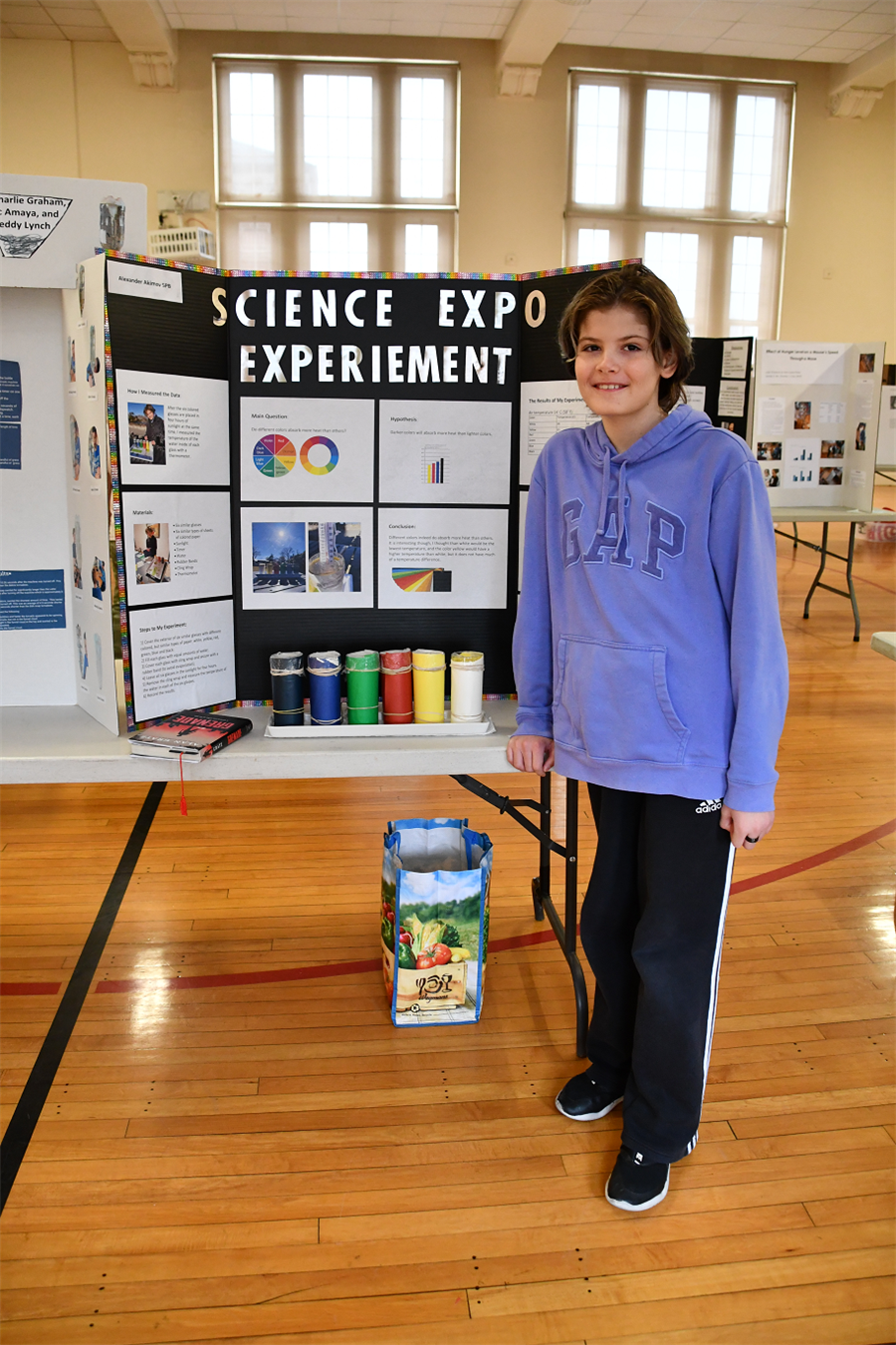 student stands in front of experiment