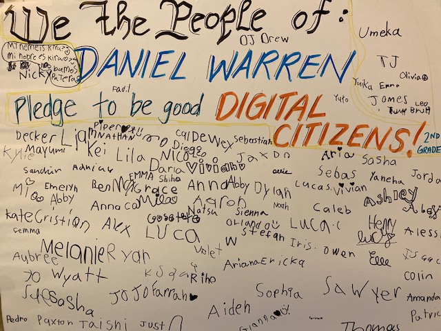 Elementary students signed a poster pledging to be good digital citizens