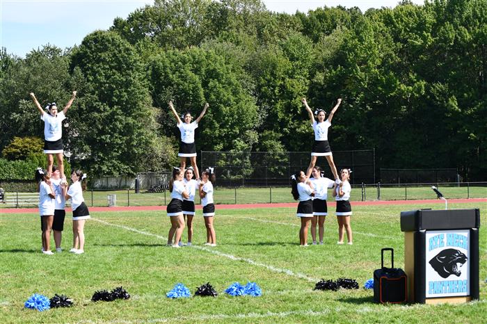 Rye Neck cheerleaders mid-routine on the field